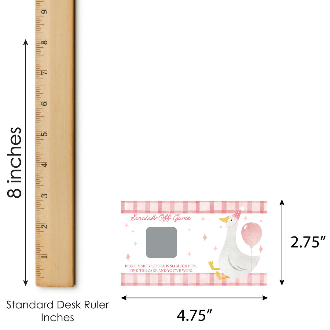 Stork scratch-off game with dimensions shown on a standard desk ruler.