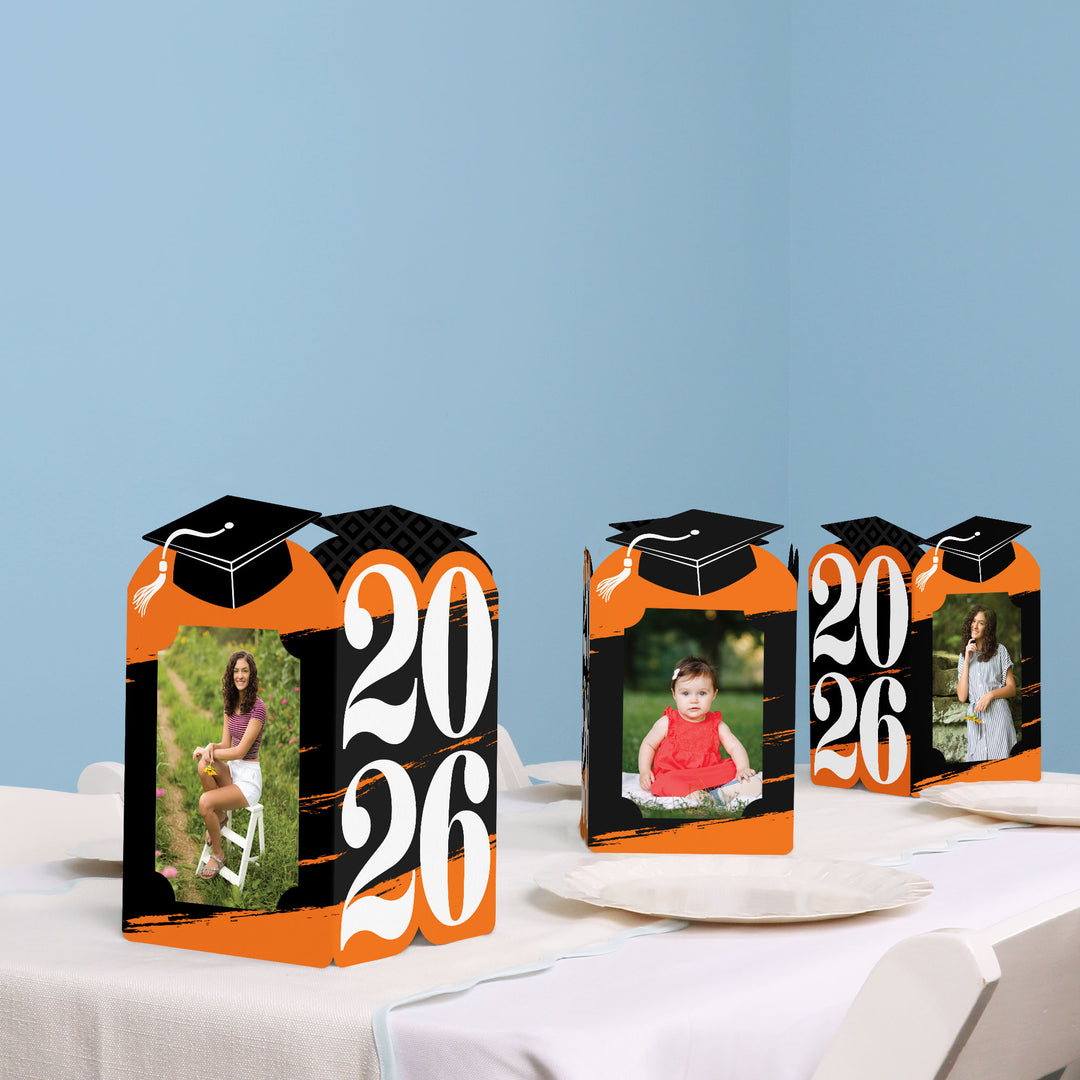 Orange graduation table decor with photo holder centerpieces