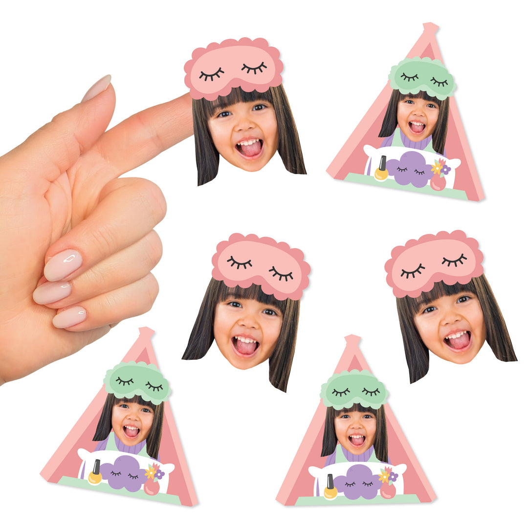 A collection of custom face cut-out stickers with a photo of a girl in a sleep mask, designed in two different shapes, being held between fingers.