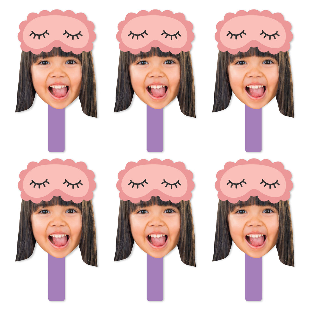 A set of six face cut-out paddles with a sleeping mask design, meant for photo props at a pajama slumber party.
