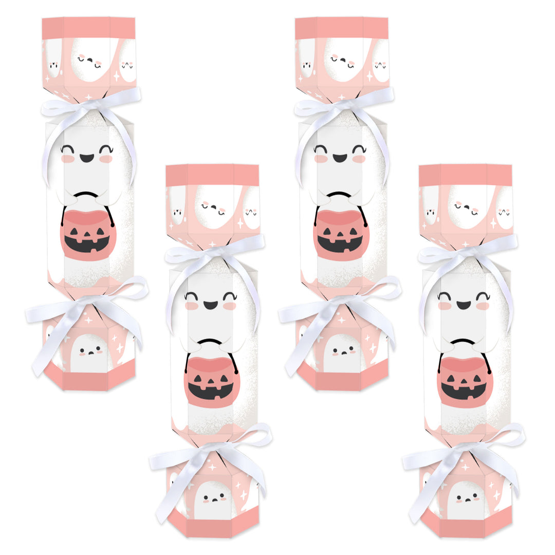 A set of 12 flat cardboard party favor boxes with a pink pumpkin design, tied with white satin ribbon.