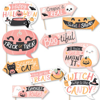 A set of colorful Halloween-themed photo booth props with various text and imagery related to the Halloween holiday.