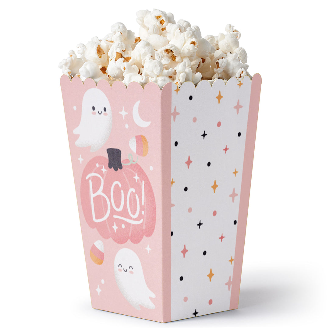 A pink popcorn treat box with a pumpkin and ghosts pattern, filled with popcorn.
