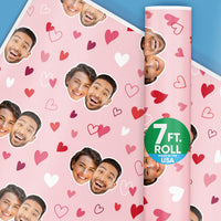 A roll of custom Valentine's Day wrapping paper with a pink and red hearts pattern, and spaces for上传 photos. The roll is marked with a '7 ft.