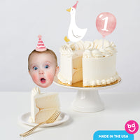 Baby girl first birthday cake with goose topper