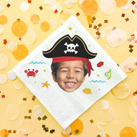 Children's party napkin with pirate-themed design on a yellow background