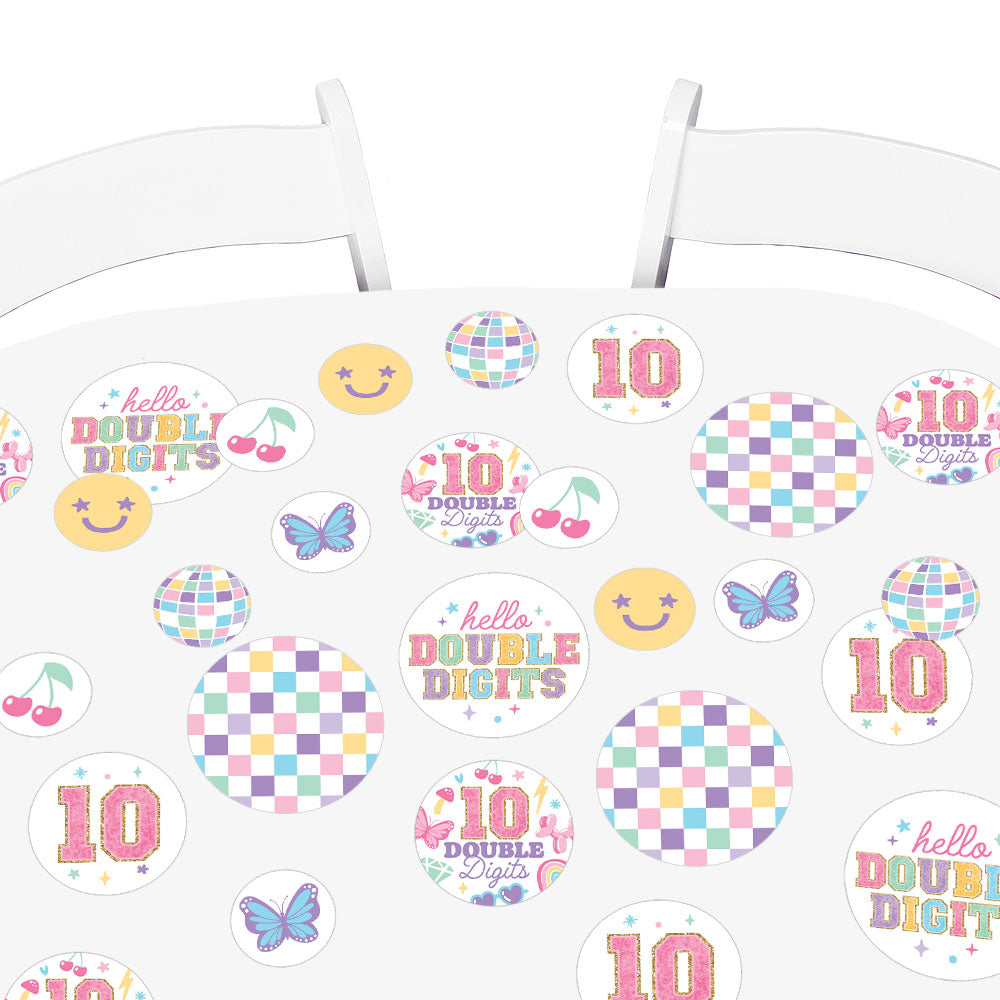 Confetti scattered on girls birthday table setup