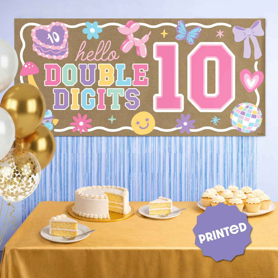 Birthday backdrop banner styled behind dessert table