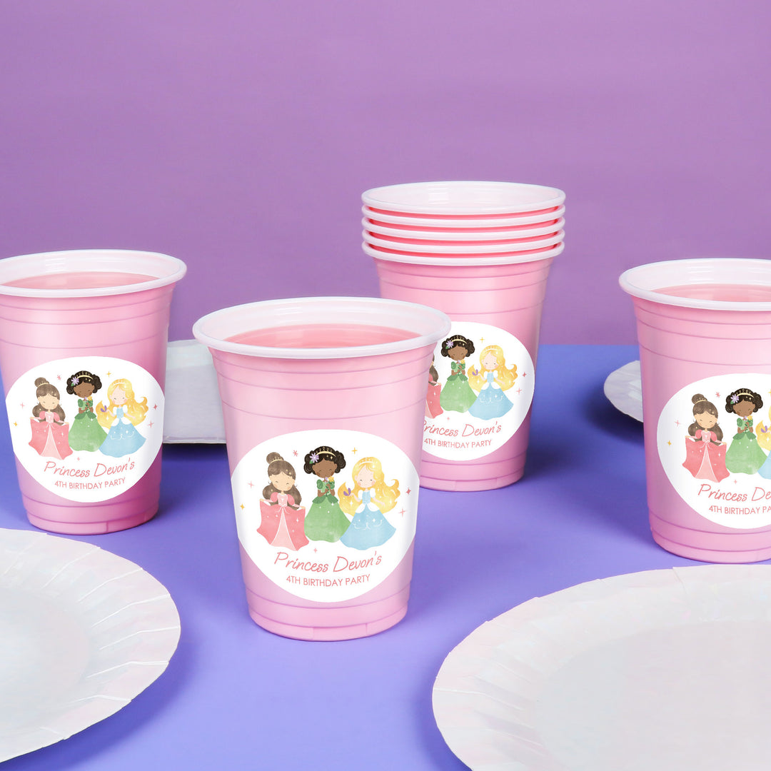 Custom Pink party cups with princess-themed labels on a purple background