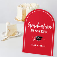 Red grad party table sign design close-up for drinks and dessert station