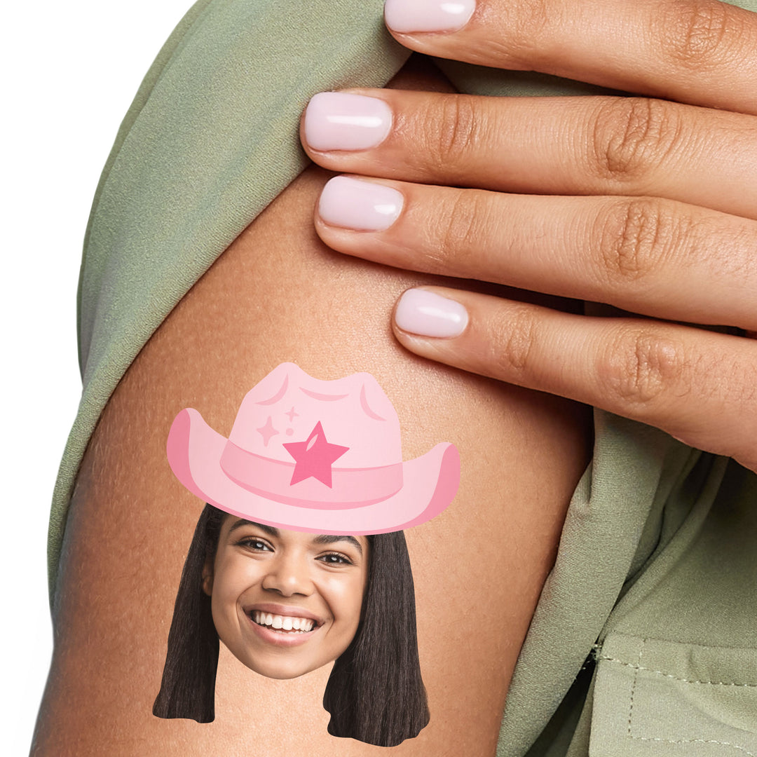 A close-up of a person's arm with a custom temporary tattoo of a pink cowboy hat superimposed on a photo of a smiling face.