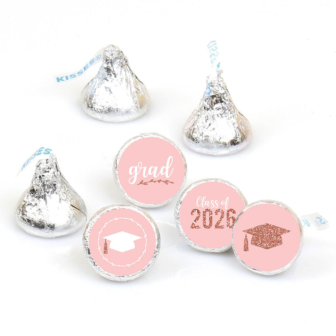 Graduation-themed pink candy wraps with 'grad' and 'class of 2026' text on silver Hershey's kisses.