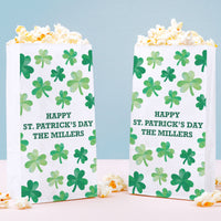 Two popcorn boxes with shamrock pattern and 'Happy St. Patrick's Day' text on a light blue background.