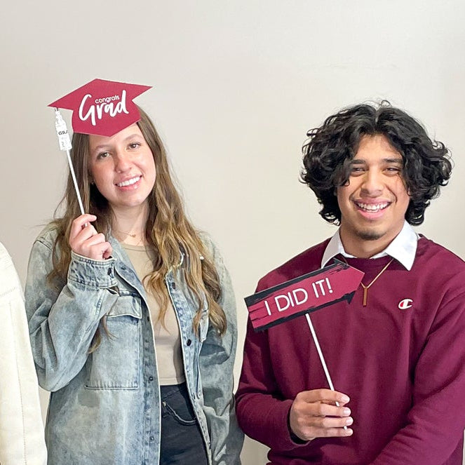Group of people holding up signs with various messages in a room.