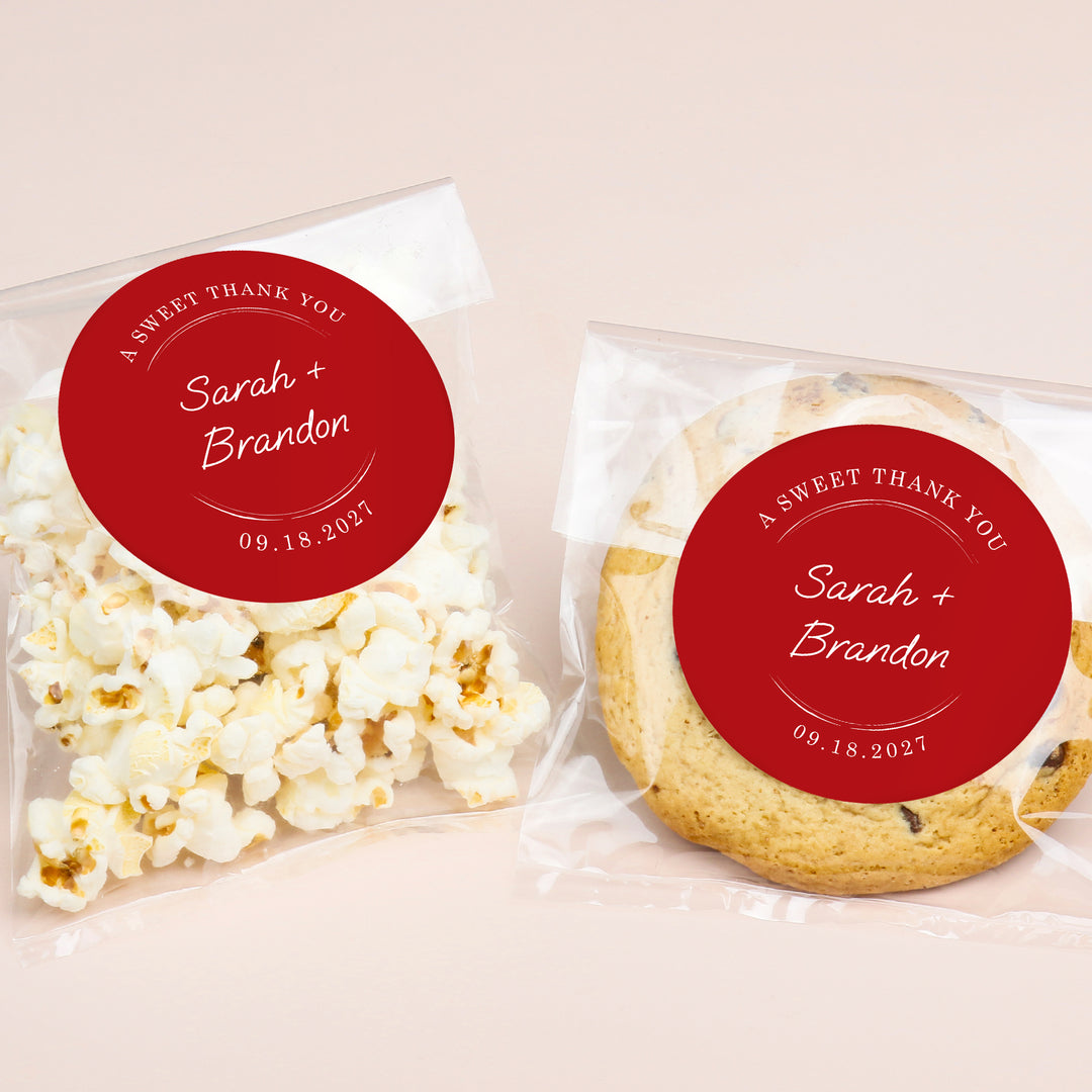 Two packaged treats, one with popcorn and the other with a cookie, each featuring a red label with personalized text.