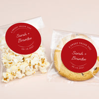 Two packaged treats, one with popcorn and the other with a cookie, each featuring a red label with personalized text.
