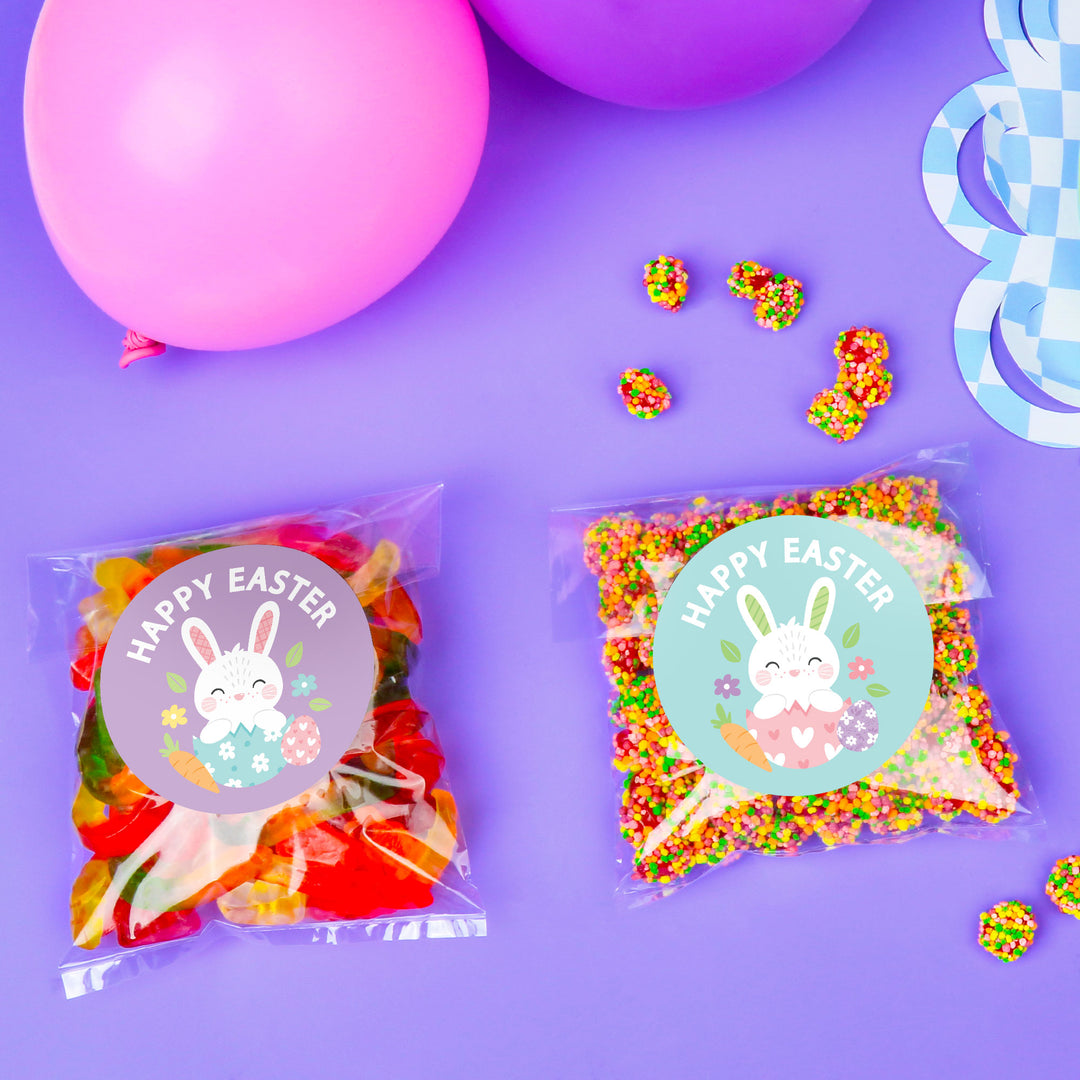 Two packages of colorful Easter treats with bunny graphics on a purple background.