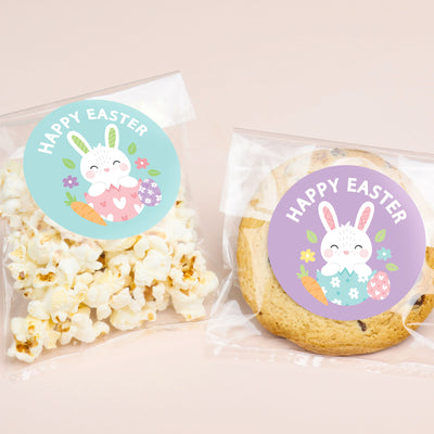 Popcorn and cookie packages with Easter-themed stickers on a light pink background