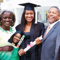 Family cheering with custom graduation photo paddle at ceremony