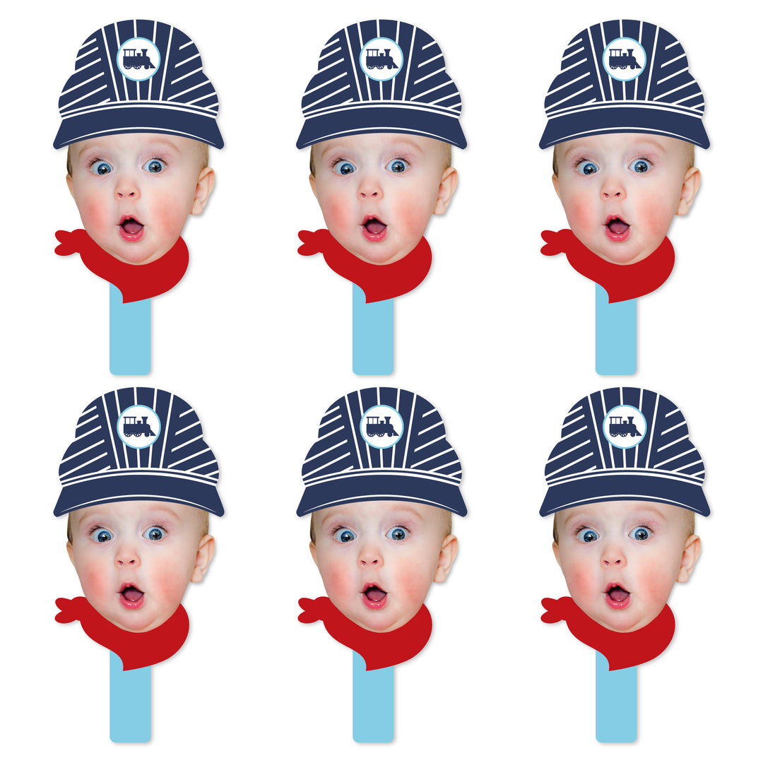 A set of six face cut-out paddles with a conductor design, featuring a blue and white striped hat and a red scarf.