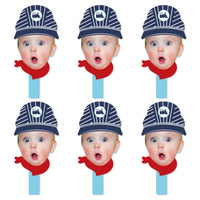 A set of six face cut-out paddles with a conductor design, featuring a blue and white striped hat and a red scarf.