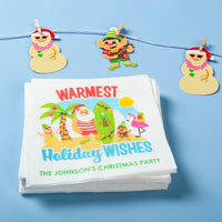 Stack of Christmas-themed napkins with cartoon elf on beach characters on a blue background