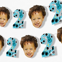 Children's custom birthday banner with number '2' and faces on a white background