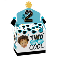 A blue gable treat box with a '2' symbol, sunglasses illustrations, and a custom photo space, designed for a boy's 2nd birthday party.