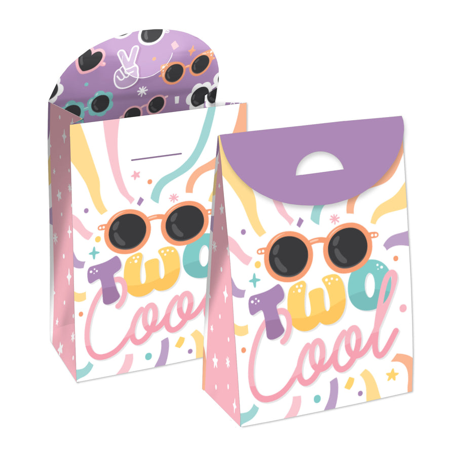 Two pastel-colored birthday gift favor bags with 'Two Cool' text and sunglasses motif, in an open top box view.
