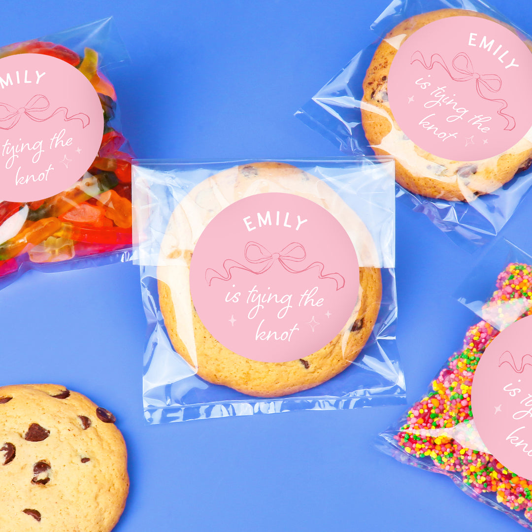 Cookies with personalized pink labels on a blue background