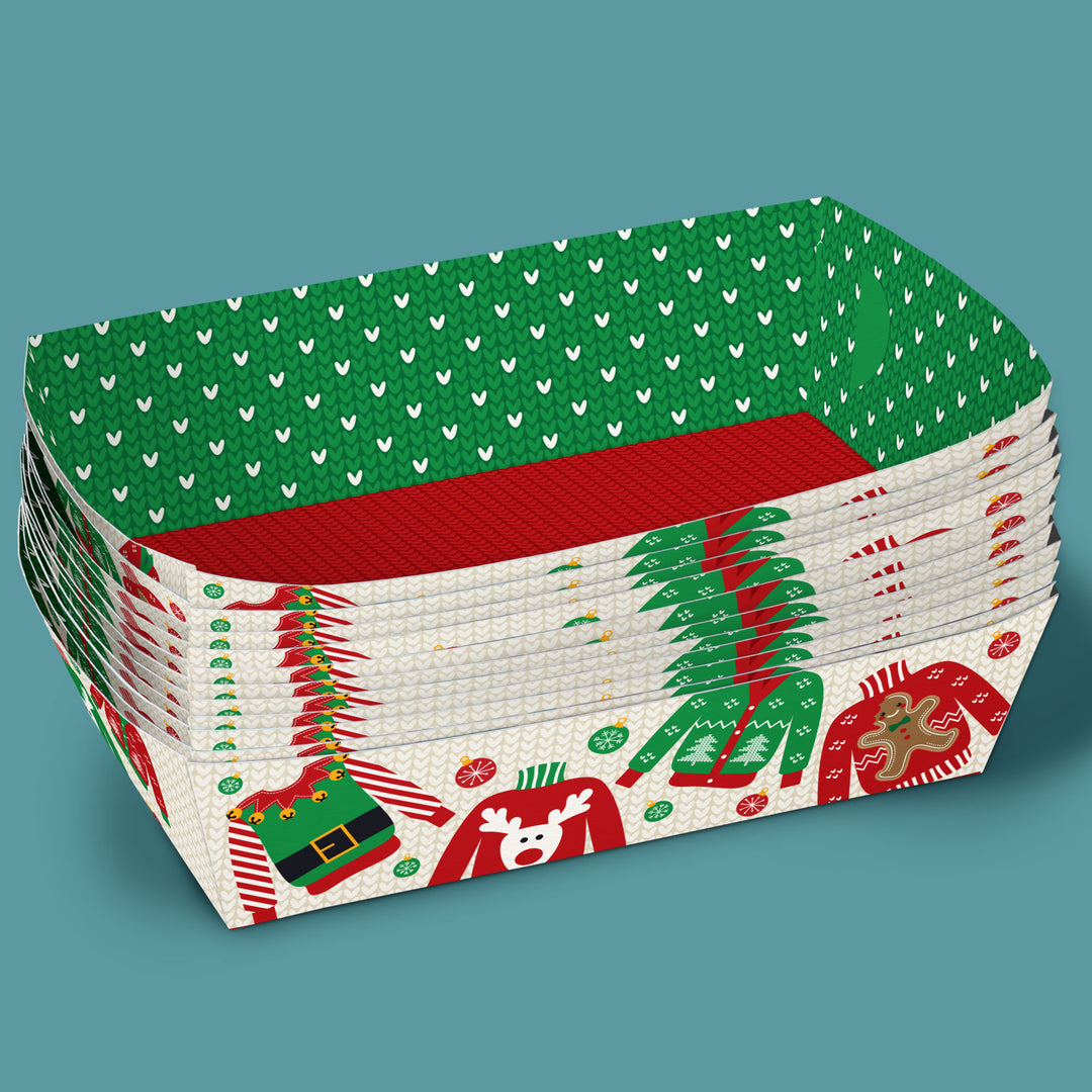 Stack of Christmas-themed paper plates with green, red, and white design on a teal background