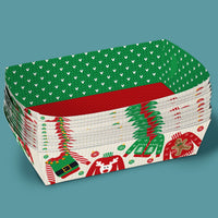 Stack of Christmas-themed paper plates with green, red, and white design on a teal background