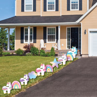 Unicorn and rainbow decorative lawn ornaments in front of a house