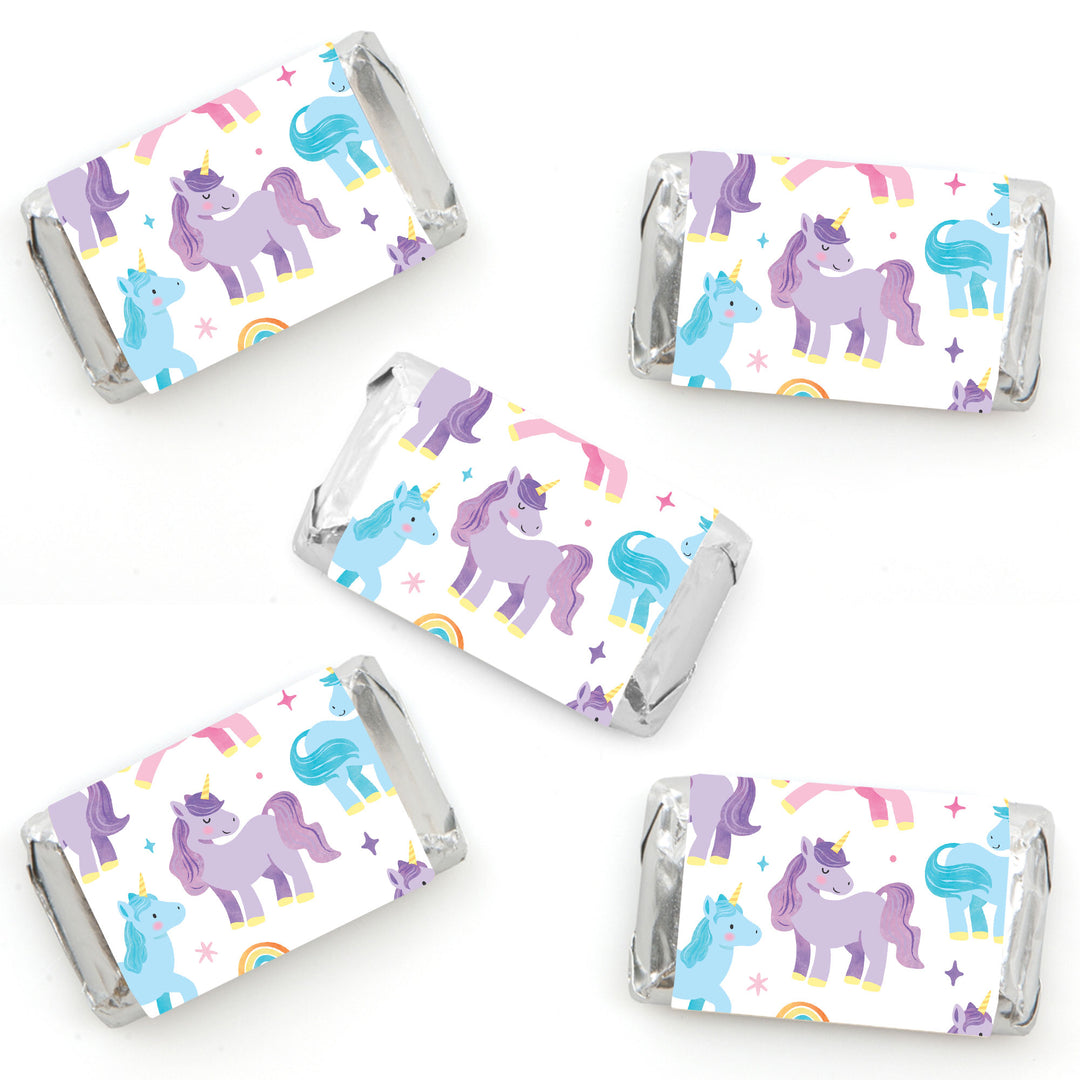 Unicorn and rainbow patterned candy wrappers on a white background perfect for unicorn party favors 