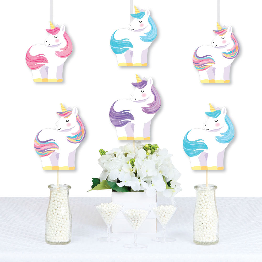 Unicorn-themed Party decoration with flowers and small bottles on a white background