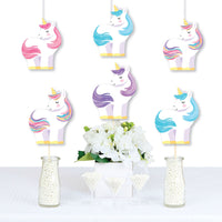 Unicorn-themed Party decoration with flowers and small bottles on a white background