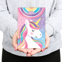 Person holding a colorful card with a unicorn design against a gray background