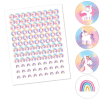 Sheet of unicorn and rainbow stickers meant for small candy favors with close-up illustrations on a white background