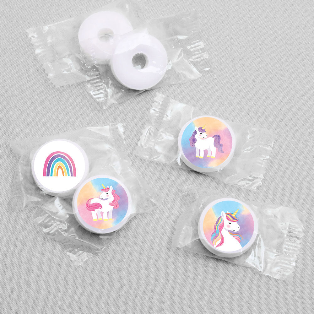 White candies with unicorn and rainbow stickers designs in clear packaging on a gray background