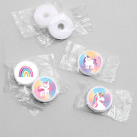 White candies with unicorn and rainbow stickers designs in clear packaging on a gray background