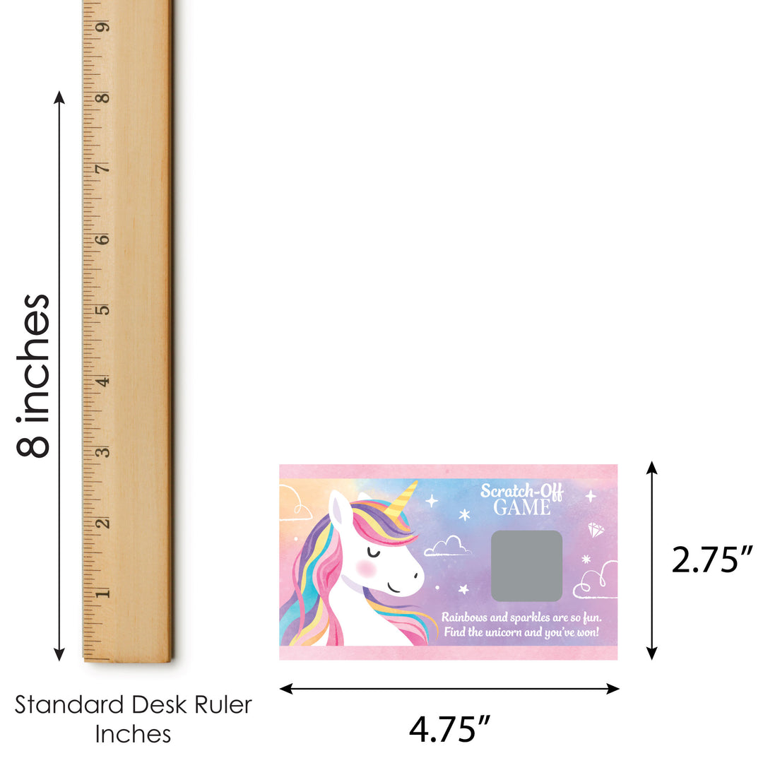 Scratch-off game card with unicorn design next to a ruler for size reference