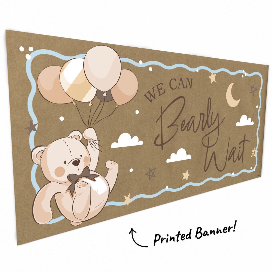 Close-up of teddy bear with balloons on baby shower banner
