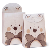 Two baby shower goodie bags with teddy bear designs, featuring ears on top and a bow tie in the front, set against a white background.