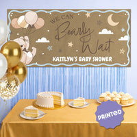 Teddy bear baby shower banner styled behind dessert table