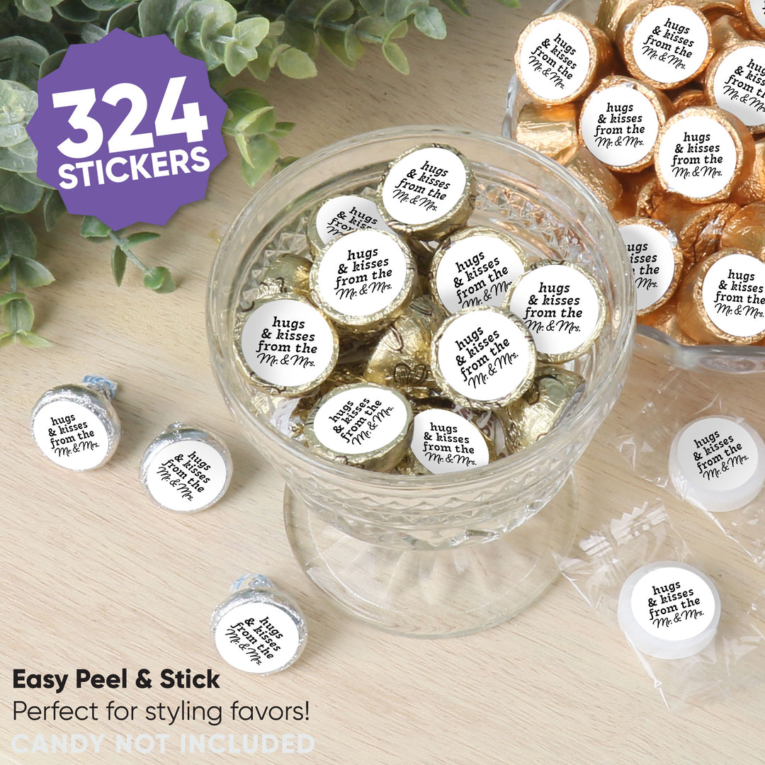 Stickers with 'hugs & kisses from the Mr. & Mrs.' text on candies in a glass bowl, surrounded by greenery.