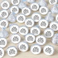 Hershey's Kisses with personalized labels on a wooden surface