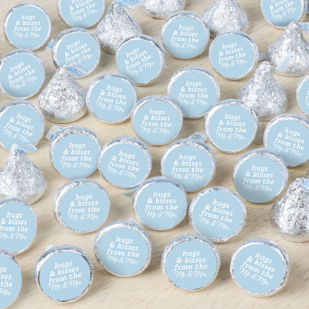 Hershey's kisses with personalized labels on a wooden surface