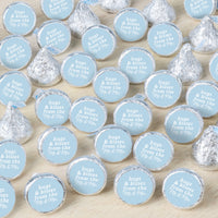 Hershey's kisses with personalized labels on a wooden surface