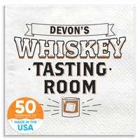 A white paper napkin with 'WHISKEY TASTING ROOM' printed in black text and a graphic of a drink glass.