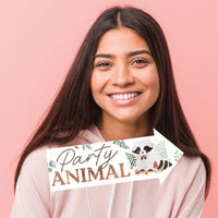 Woman Holding a Party Photo Booth Prop that reads  'Party Animal' 
